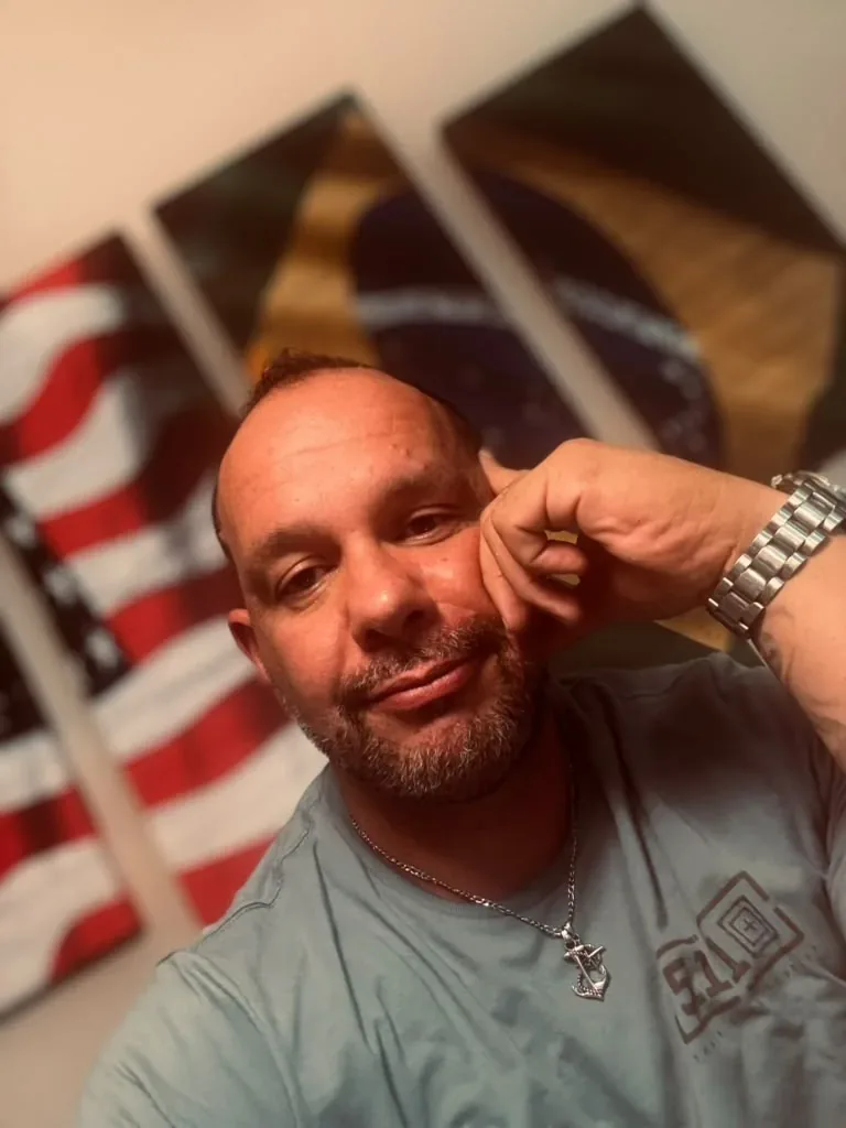 Wilson at home in front of American and Brazilian flags