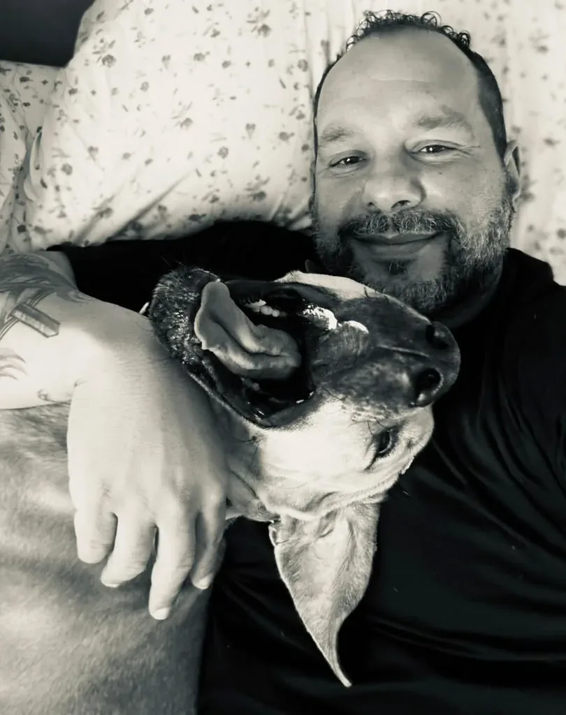 Wilson resting with his dog, black-and-white photo